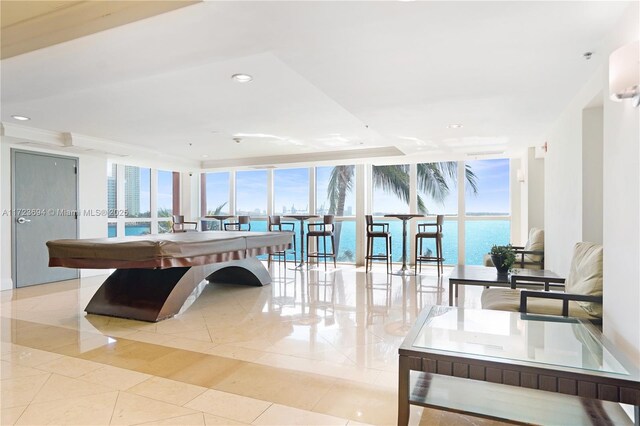 1155 Brickell Bay Dr Unit 704, Miami, FL 33131 - recreation room with a wall of windows, tile patterned flooring, healthy amount of natural light, a water view, and recessed lighting
