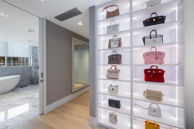 walk in closet featuring light hardwood / wood-style floors