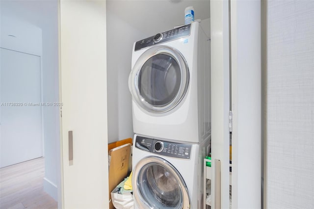 laundry area featuring stacked washing maching and dryer