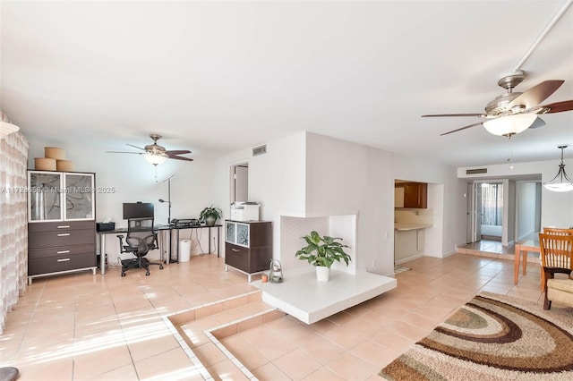 tiled living room featuring ceiling fan