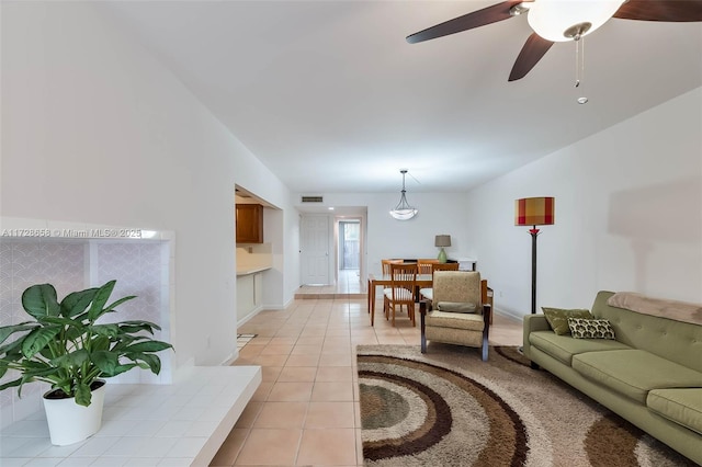 living room with light tile patterned flooring and ceiling fan