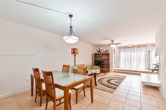 tiled dining area featuring ceiling fan