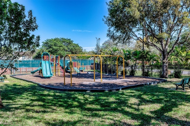 view of playground with a lawn