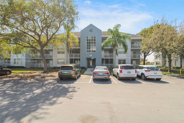 view of building exterior featuring uncovered parking