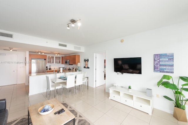 living room with light tile patterned floors and ceiling fan