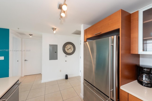 kitchen with stainless steel fridge, electric panel, and light tile patterned flooring