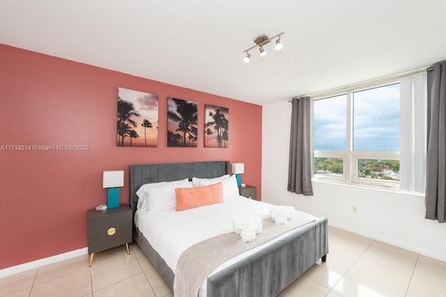 tiled bedroom with rail lighting