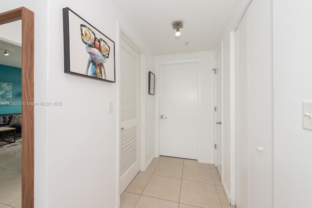 hall with light tile patterned flooring