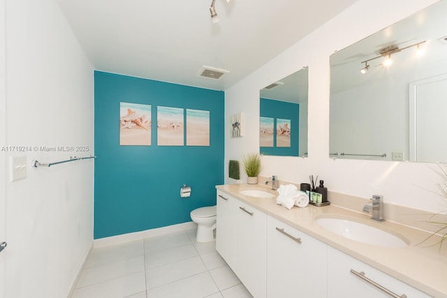 bathroom featuring tile patterned flooring, vanity, and toilet