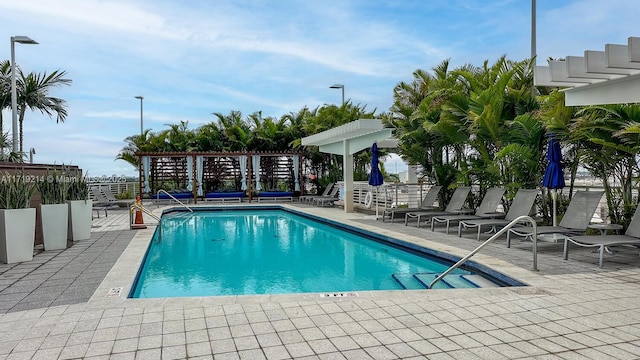 view of swimming pool featuring a pergola and a patio