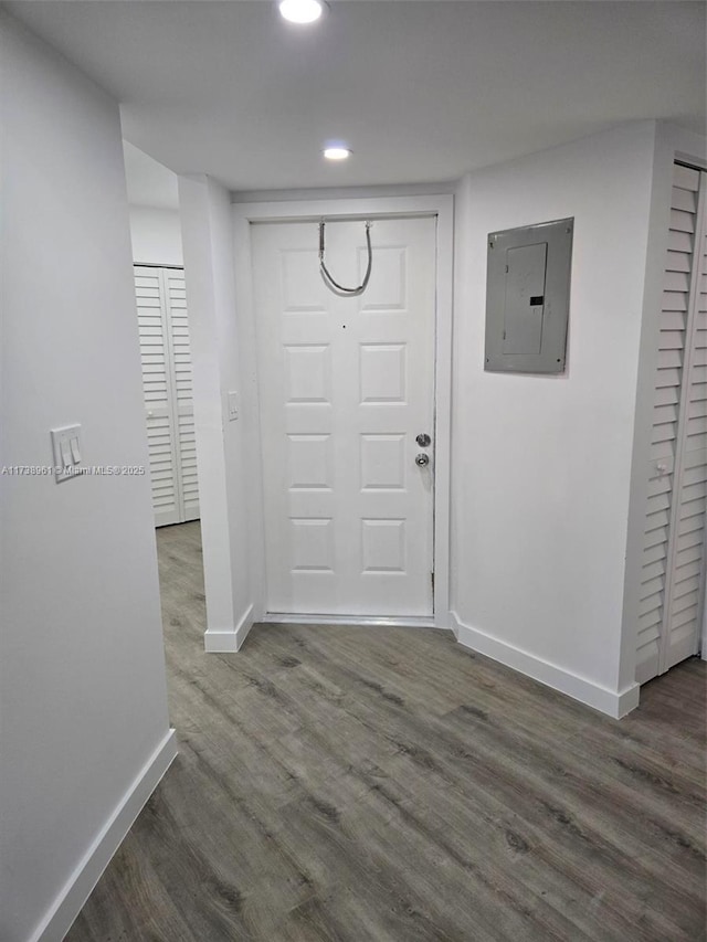 entryway with dark wood-type flooring and electric panel