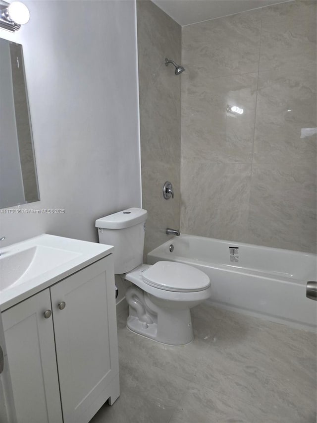 full bathroom featuring tiled shower / bath combo, vanity, tile patterned floors, and toilet