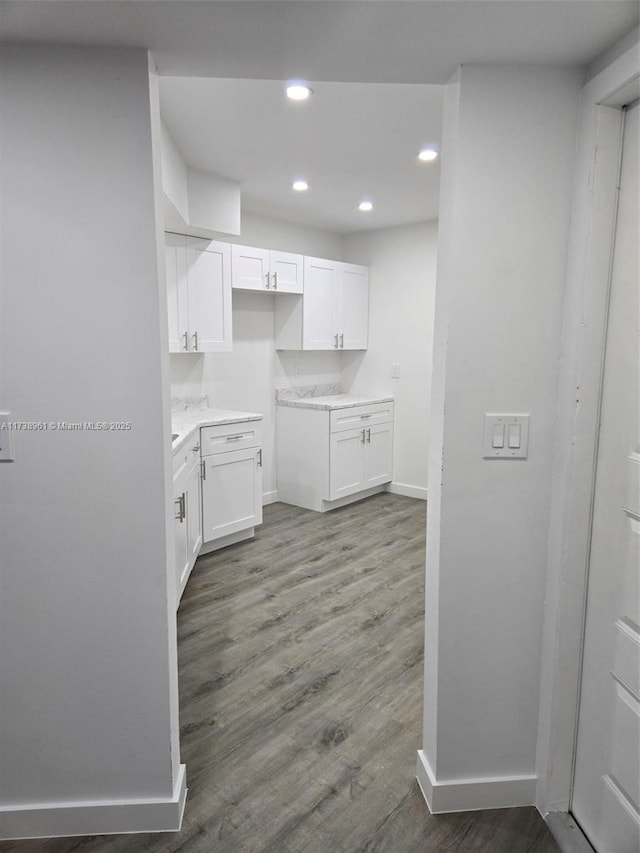 kitchen with dark wood-type flooring and white cabinets