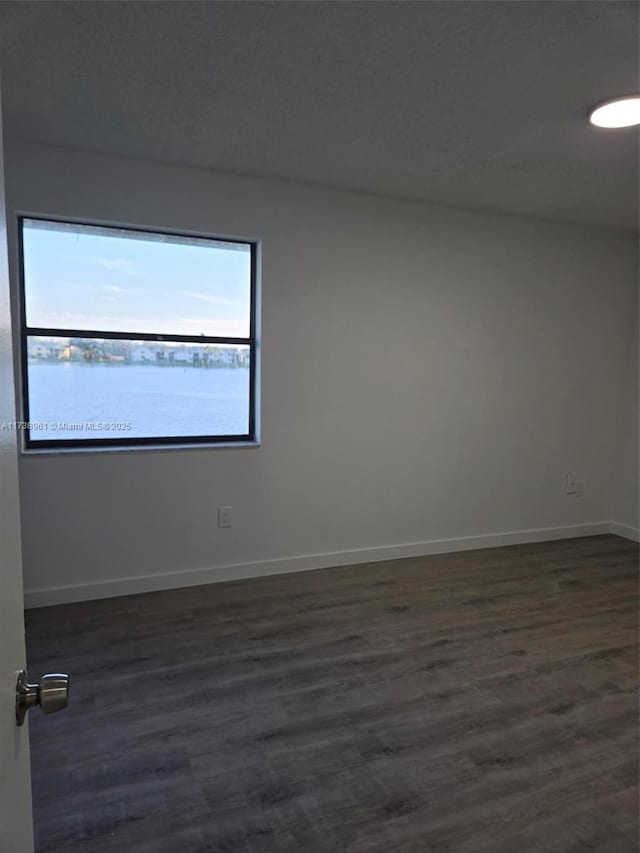 empty room featuring dark hardwood / wood-style floors