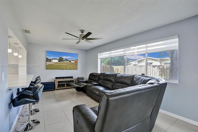 tiled living room featuring ceiling fan