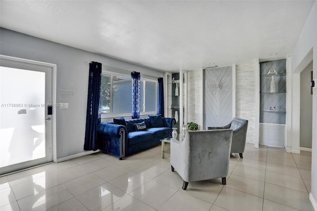 tiled living room featuring a textured ceiling