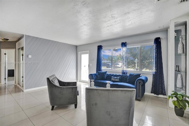 living room featuring light tile patterned flooring and a textured ceiling