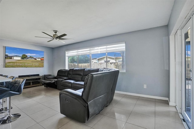 living room featuring light tile patterned floors and ceiling fan