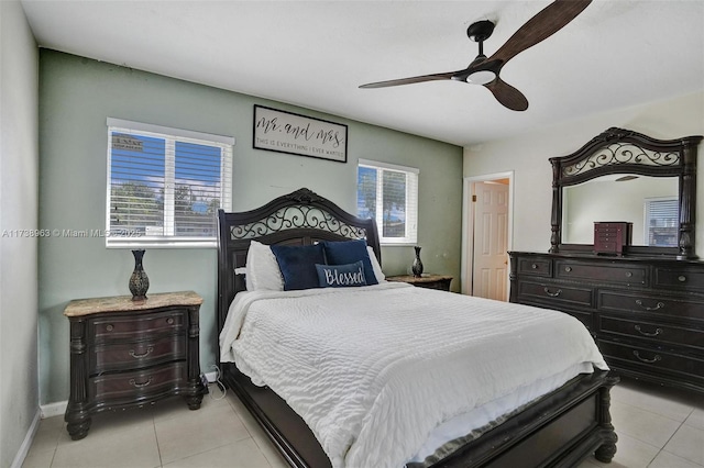 bedroom with multiple windows, light tile patterned floors, and ceiling fan