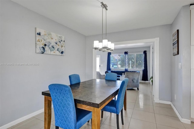 dining space with a chandelier and light tile patterned flooring