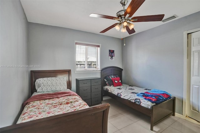 tiled bedroom with ceiling fan