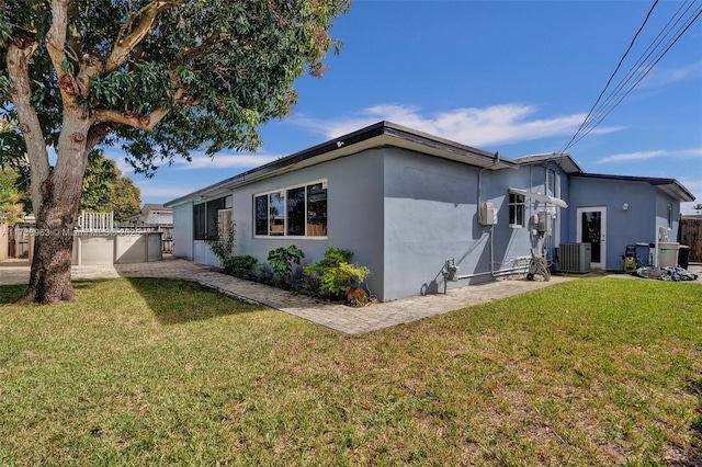 view of property exterior featuring a lawn and central air condition unit