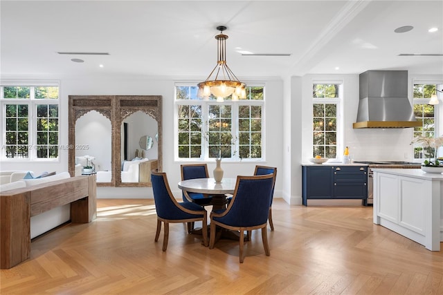 dining room with light parquet flooring and crown molding