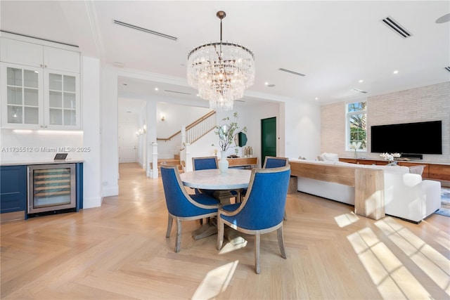 dining area featuring a chandelier, recessed lighting, beverage cooler, visible vents, and stairway