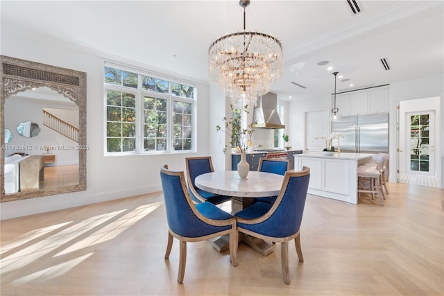 dining room with a chandelier, ornamental molding, visible vents, and baseboards