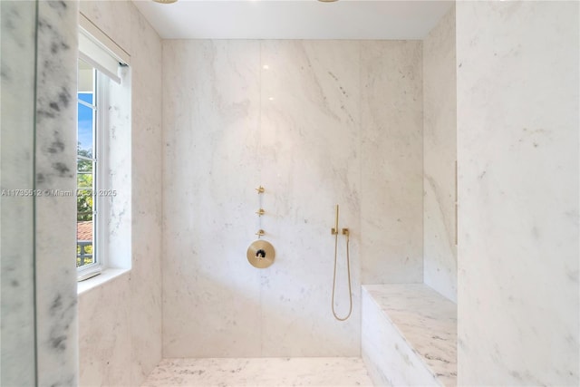 full bathroom featuring a marble finish shower