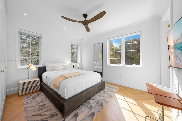 bedroom featuring ceiling fan, crown molding, and light parquet flooring