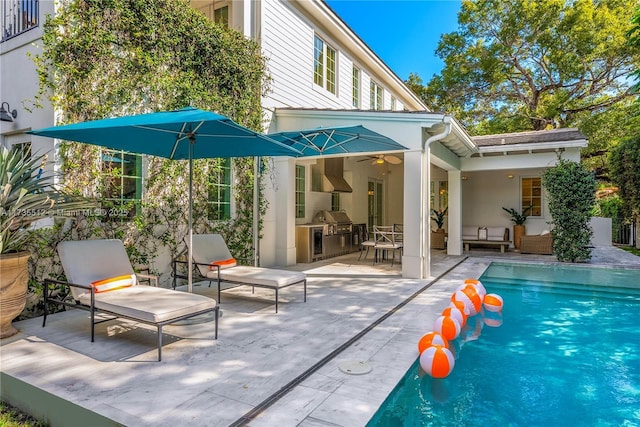 rear view of property featuring ceiling fan, outdoor lounge area, and a patio area