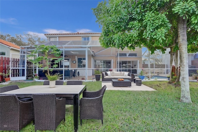 back of property with outdoor lounge area, a patio area, and a lanai