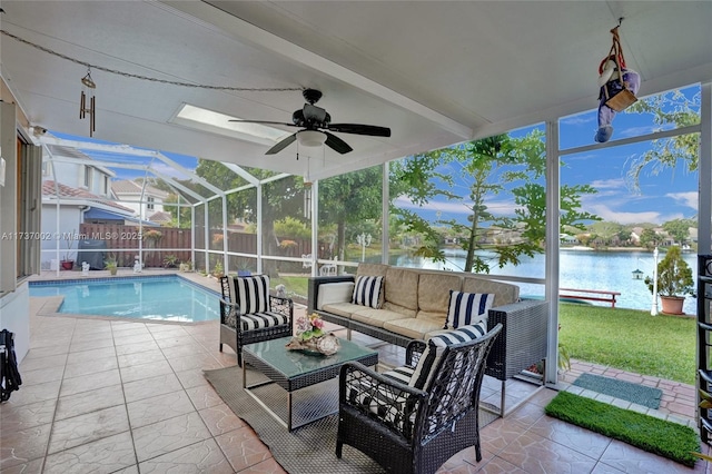 view of swimming pool featuring a lanai, ceiling fan, a water view, an outdoor living space, and a patio area