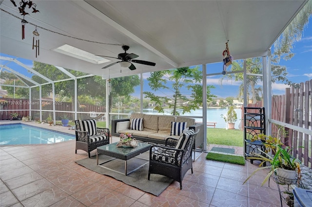 view of patio / terrace with a water view, a lanai, ceiling fan, an outdoor hangout area, and a fenced in pool