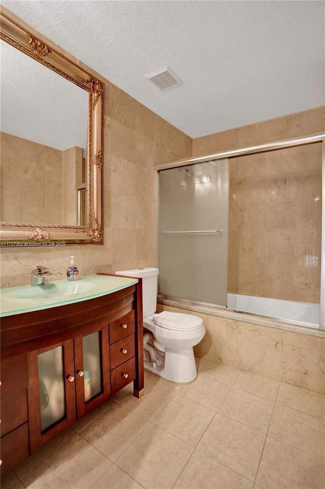 full bathroom featuring tiled shower / bath, tile walls, decorative backsplash, tile patterned flooring, and a textured ceiling