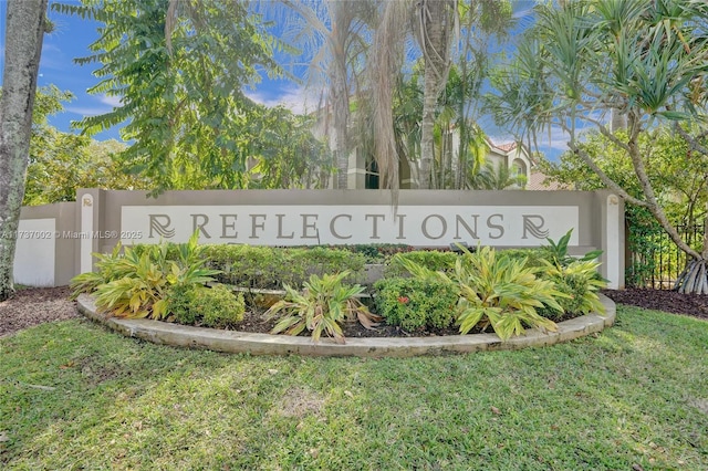 community / neighborhood sign with a yard