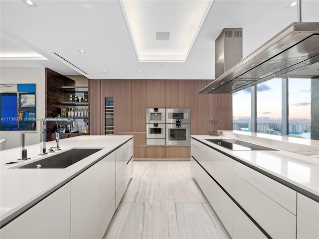 kitchen with sink, extractor fan, double oven, black electric stovetop, and white cabinets