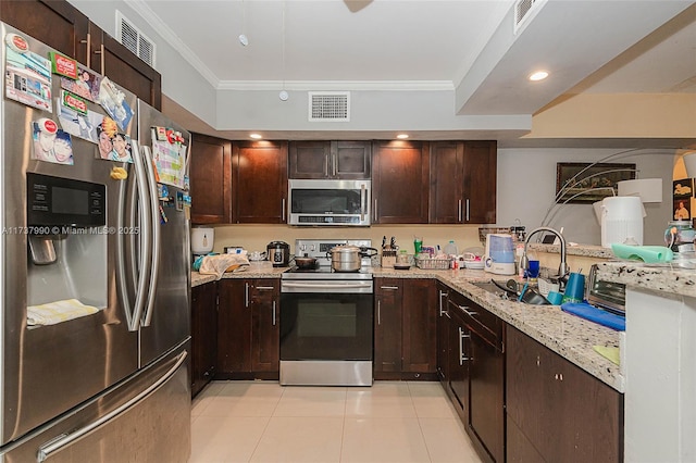 kitchen featuring sink, crown molding, light stone counters, light tile patterned floors, and appliances with stainless steel finishes