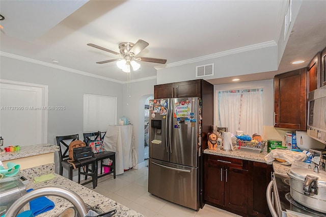 kitchen with light tile patterned floors, crown molding, stainless steel appliances, and ceiling fan