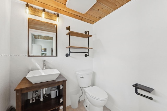 half bath with wooden ceiling, vanity, and toilet