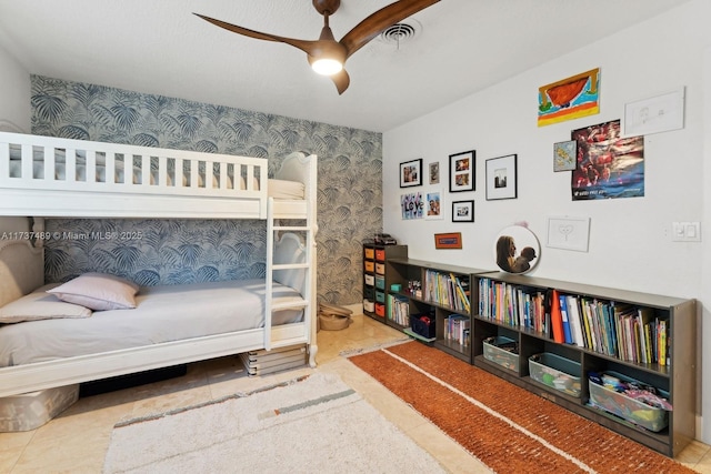 bedroom featuring a ceiling fan, visible vents, and wallpapered walls