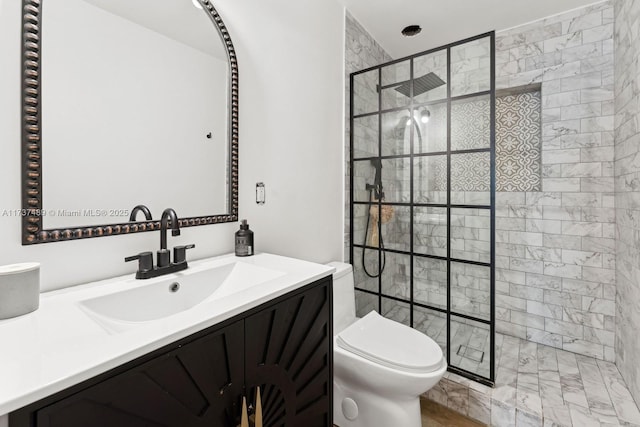 bathroom featuring vanity, toilet, and a walk in shower