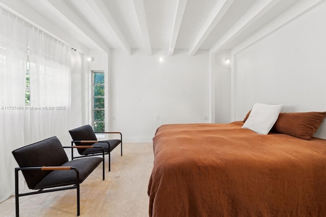 bedroom with beamed ceiling and baseboards