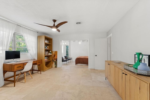 office space with ceiling fan and visible vents