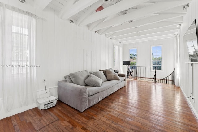 living room with lofted ceiling with beams and wood finished floors