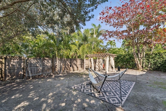 view of yard with a patio area, fence, and a pergola