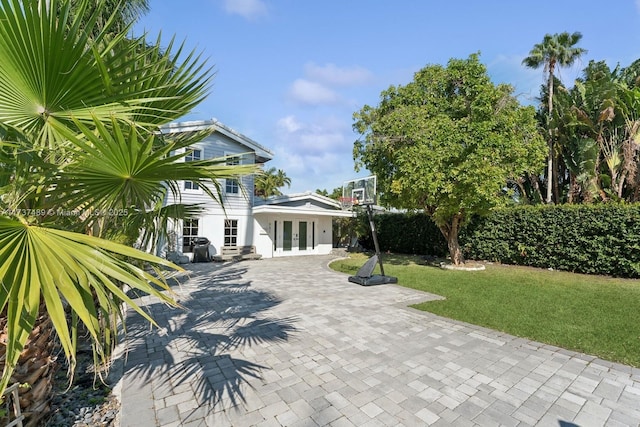 exterior space with a lawn and french doors