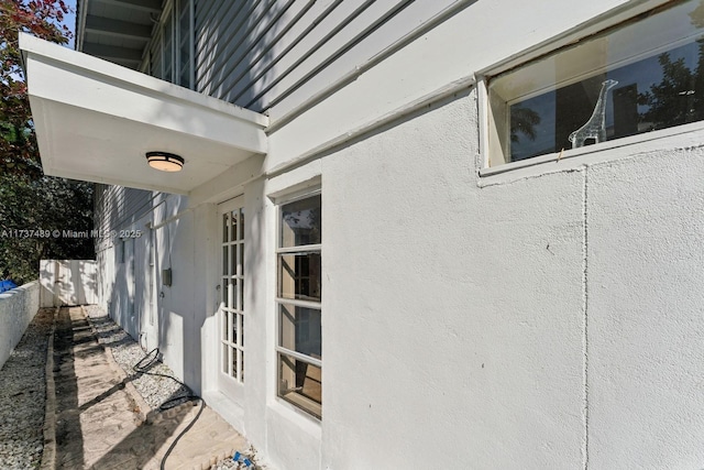 view of property exterior featuring fence and stucco siding