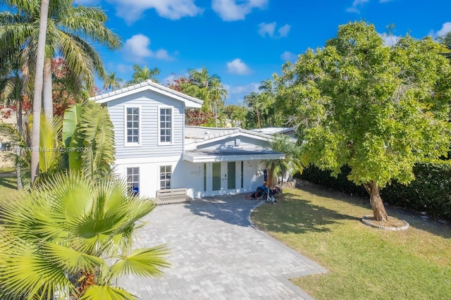 view of front of property with a front lawn and decorative driveway